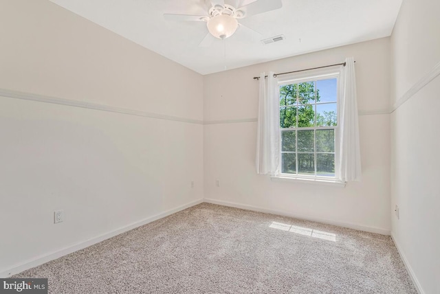 empty room featuring carpet, a ceiling fan, and baseboards