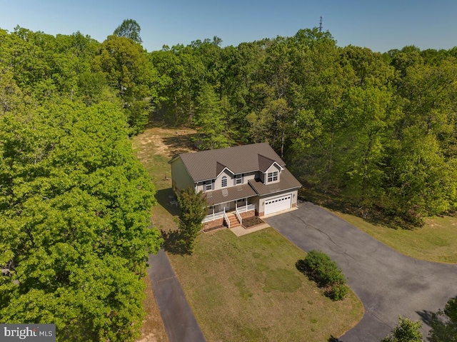 view of subject property featuring a heavily wooded area