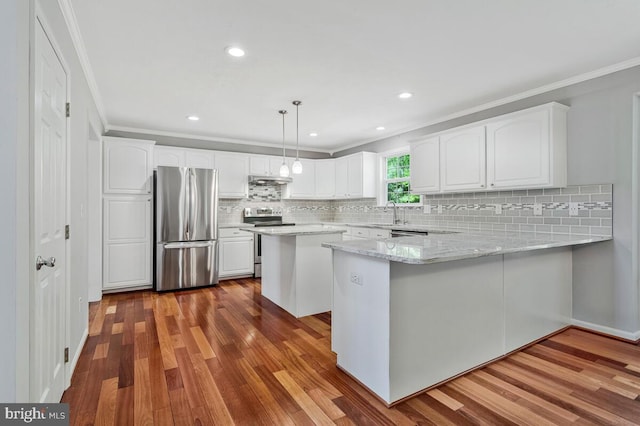 kitchen featuring appliances with stainless steel finishes, ornamental molding, dark wood finished floors, white cabinetry, and decorative backsplash