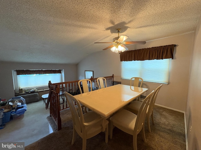 carpeted dining area featuring a textured ceiling, baseboards, a ceiling fan, and vaulted ceiling