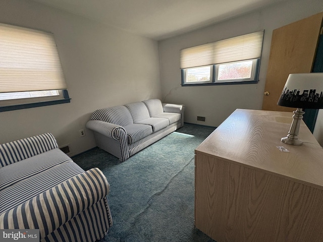 carpeted living area featuring visible vents