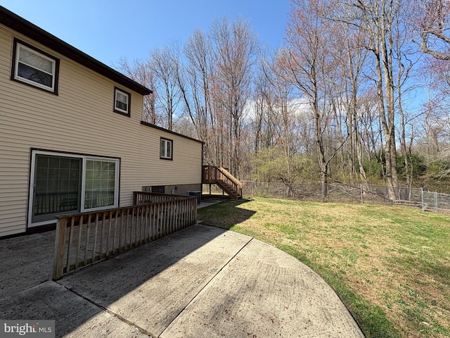 view of yard featuring fence, a patio, and stairway