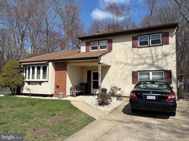 view of front of property with brick siding and a front lawn