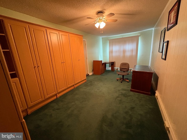 office with dark colored carpet, a textured ceiling, and a ceiling fan