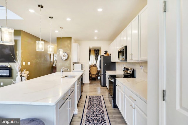 18010 Dave Anne Cir, Stewartstown, PA 17363 - kitchen featuring stainless steel appliances, a sink, an island with sink, light wood-style floors, and recessed lighting