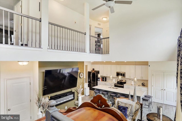 18010 Dave Anne Cir, Stewartstown, PA 17363 - living room with a towering ceiling, ceiling fan, and light wood-type flooring