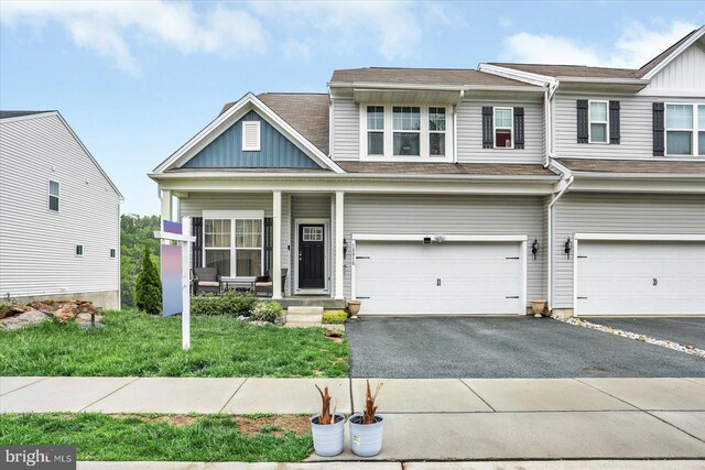 18010 Dave Anne Cir, Stewartstown, PA 17363 - view of front of house with asphalt driveway, board and batten siding, a garage, and covered porch