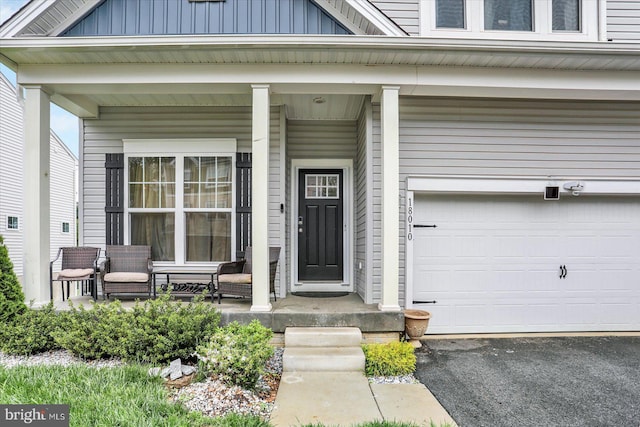 18010 Dave Anne Cir, Stewartstown, PA 17363 - property entrance featuring a porch, board and batten siding, an attached garage, and driveway