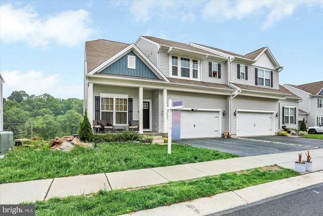 18010 Dave Anne Cir, Stewartstown, PA 17363 - view of front of property with a garage, asphalt driveway, covered porch, and board and batten siding
