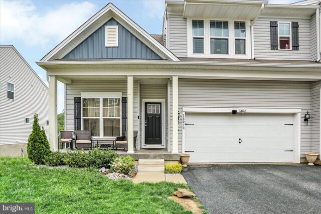 18010 Dave Anne Cir, Stewartstown, PA 17363 - view of front of house with a porch, an attached garage, board and batten siding, and driveway