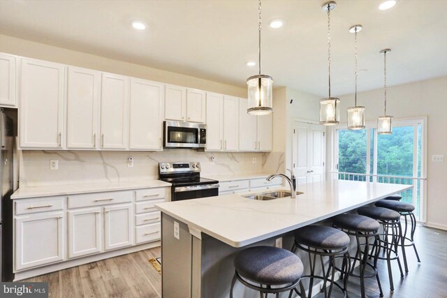 18010 Dave Anne Cir, Stewartstown, PA 17363 - kitchen with appliances with stainless steel finishes, a sink, light wood-style flooring, white cabinets, and recessed lighting
