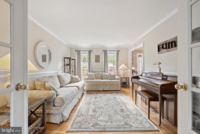 living area with light wood-style floors and ornamental molding
