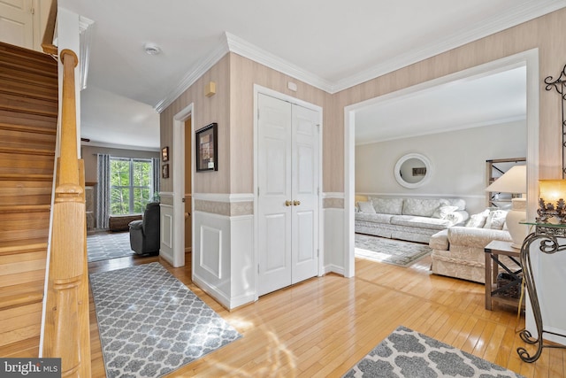 interior space featuring ornamental molding, stairway, and wood-type flooring