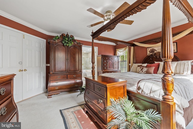 bedroom featuring ensuite bathroom, a closet, ornamental molding, ceiling fan, and light carpet