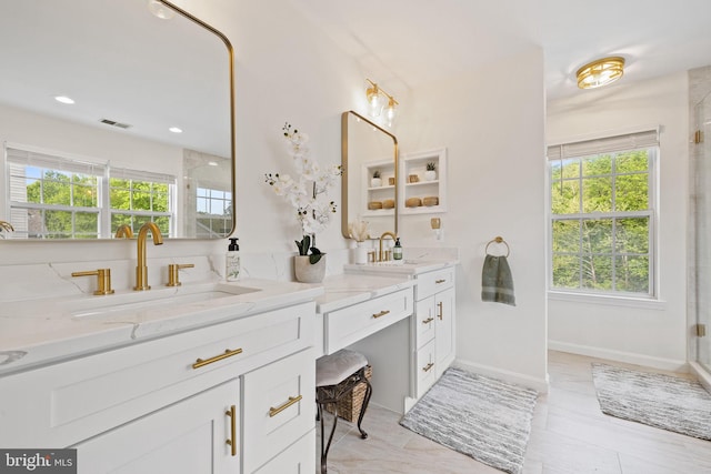 full bathroom featuring plenty of natural light, visible vents, a sink, and double vanity