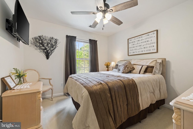 bedroom featuring light carpet, baseboards, and ceiling fan