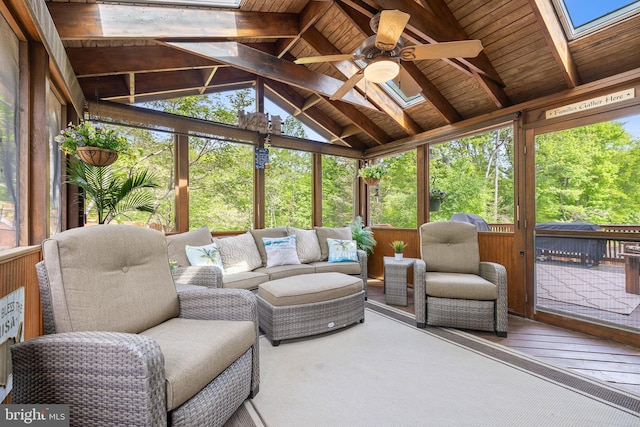 sunroom / solarium with a skylight, an outdoor living space, and a ceiling fan