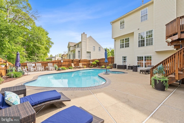 view of pool featuring a patio, an in ground hot tub, a fenced backyard, and a fenced in pool