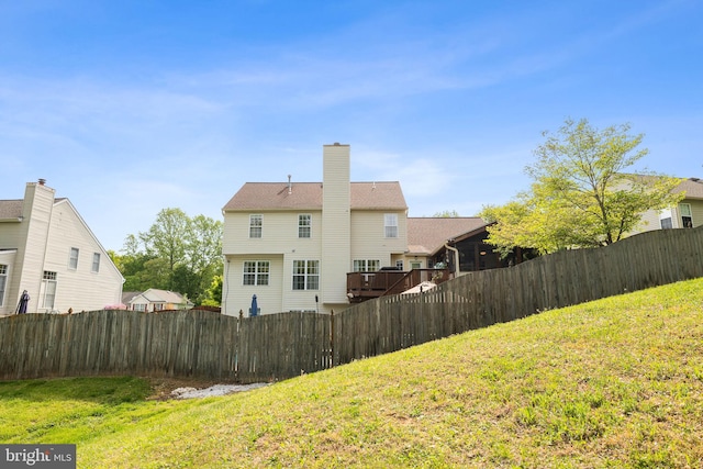 rear view of property featuring a yard and fence private yard