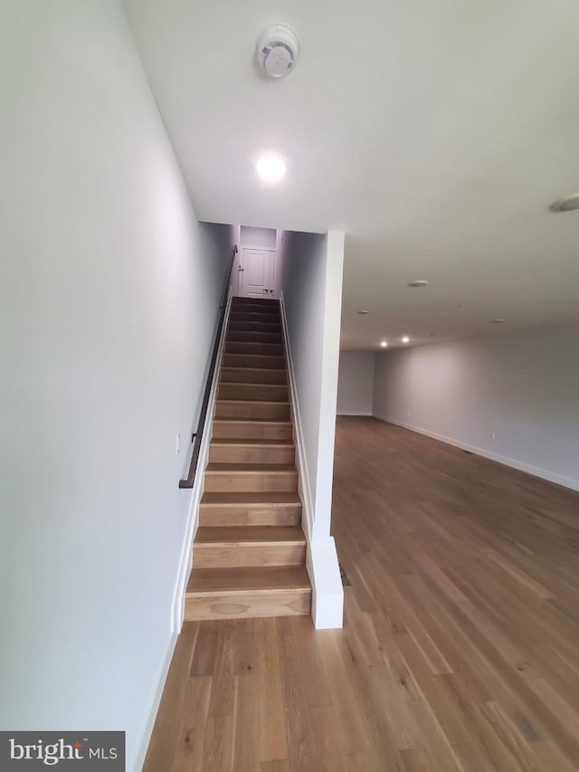 5100 Fitch St SE, Washington, DC 20019 - staircase featuring wood finished floors and baseboards
