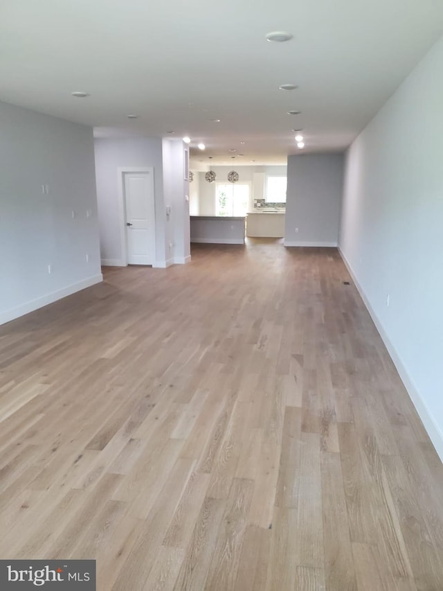5100 Fitch St SE, Washington, DC 20019 - unfurnished living room featuring light wood-type flooring and baseboards
