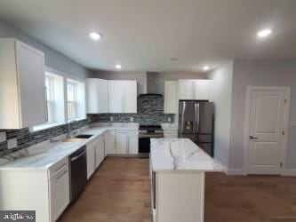 5100 Fitch St SE, Washington, DC 20019 - kitchen featuring stainless steel appliances, a kitchen island, tasteful backsplash, white cabinets, and recessed lighting