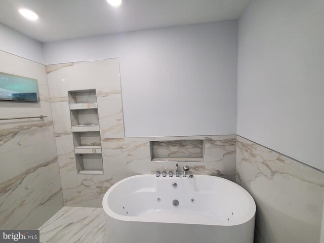 5100 Fitch St SE, Washington, DC 20019 - bathroom featuring tile walls, a soaking tub, wainscoting, and recessed lighting