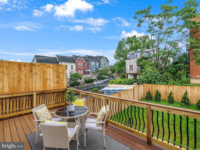 5100 Fitch St SE, Washington, DC 20019 - wooden deck with outdoor dining space and a residential view