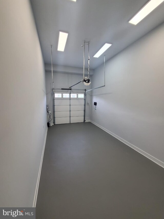 5100 Fitch St SE, Washington, DC 20019 - garage featuring baseboards and a garage door opener
