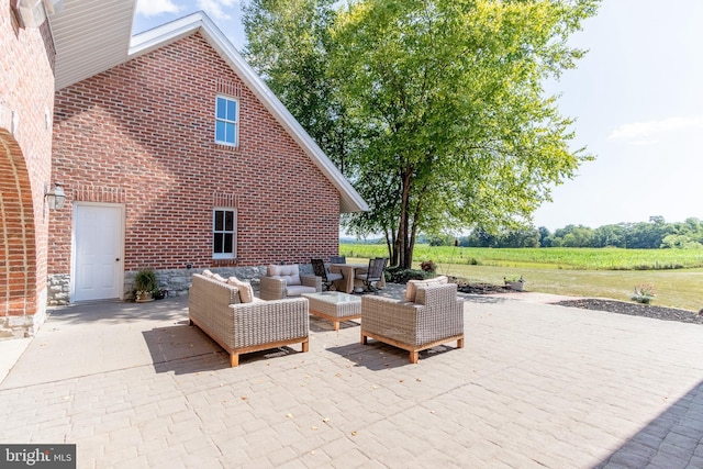 view of patio / terrace with an outdoor hangout area and a rural view