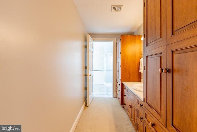 bathroom with baseboards, visible vents, and vanity