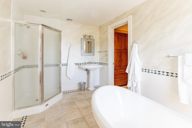 bathroom with tile patterned floors, visible vents, a tub to relax in, and a stall shower