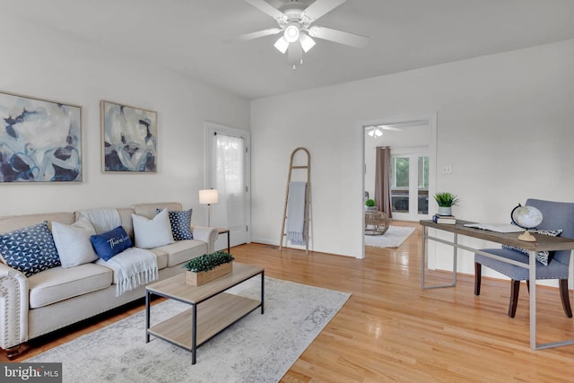living area with a ceiling fan and light wood-style floors