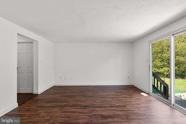 unfurnished room featuring baseboards, a textured ceiling, and dark wood-style flooring
