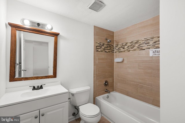 bathroom featuring a textured ceiling, vanity, shower / tub combination, toilet, and visible vents