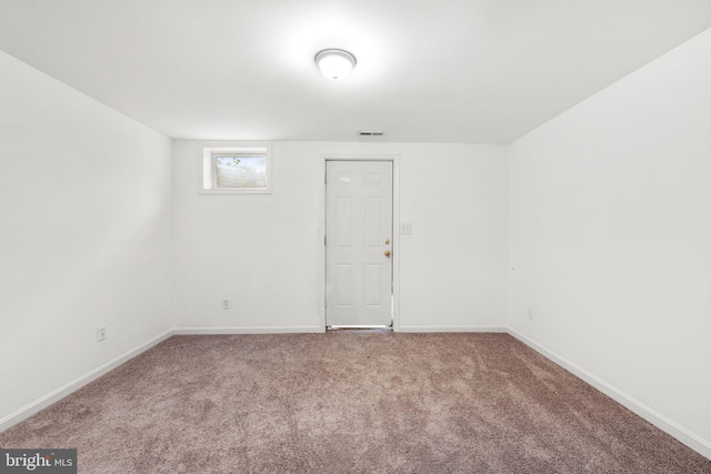 carpeted spare room with baseboards and visible vents