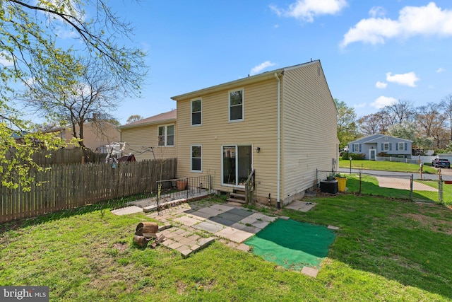 back of property with fence private yard, a yard, entry steps, and a patio area