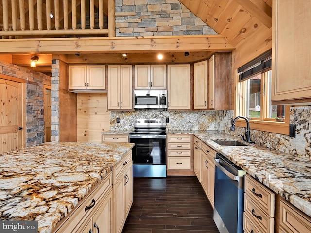 1918 Friedensburg Rd, Reading, PA 19606 - kitchen featuring light stone counters, a sink, backsplash, lofted ceiling, and appliances with stainless steel finishes
