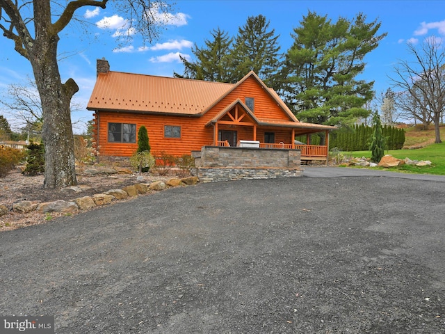 1918 Friedensburg Rd, Reading, PA 19606 - log cabin with a chimney, driveway, a porch, log veneer siding, and metal roof