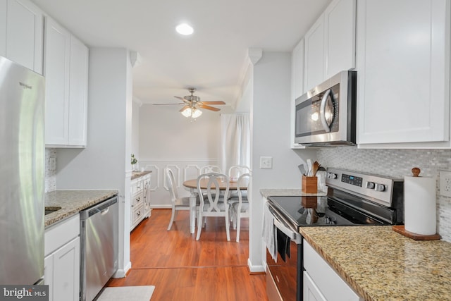 9060 Moonshine Holw Unit G, Laurel, MD 20723 - kitchen featuring appliances with stainless steel finishes, light wood finished floors, white cabinetry, tasteful backsplash, and ceiling fan