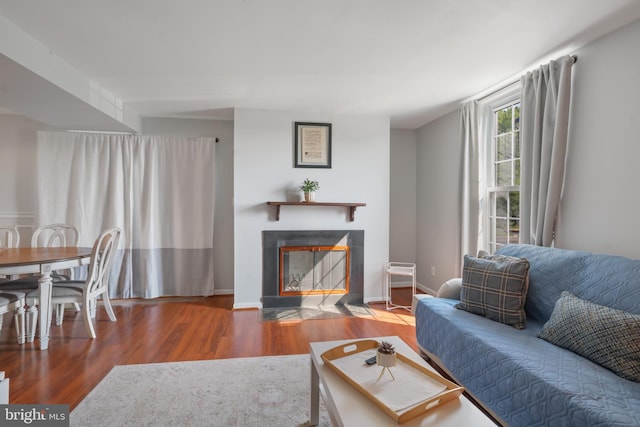 9060 Moonshine Holw Unit G, Laurel, MD 20723 - living area with a tile fireplace, wood finished floors, and baseboards