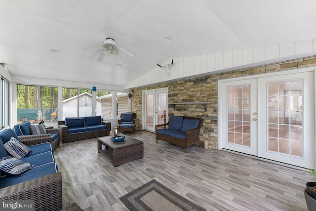 living area with vaulted ceiling, a ceiling fan, french doors, and wood finished floors