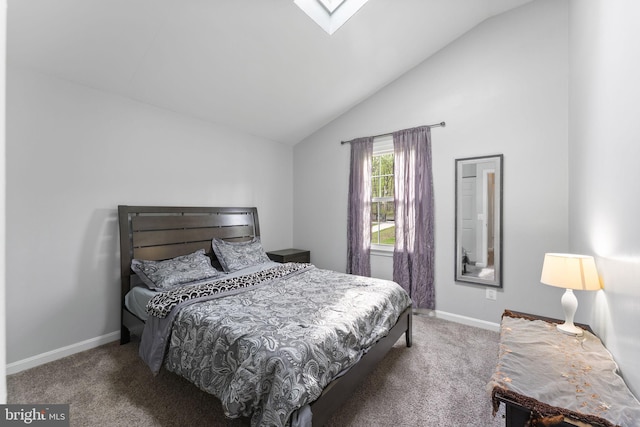 bedroom featuring baseboards, carpet flooring, and vaulted ceiling with skylight
