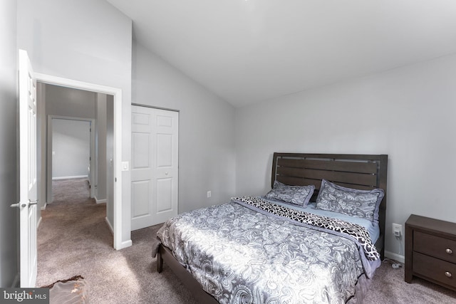 carpeted bedroom with lofted ceiling and baseboards