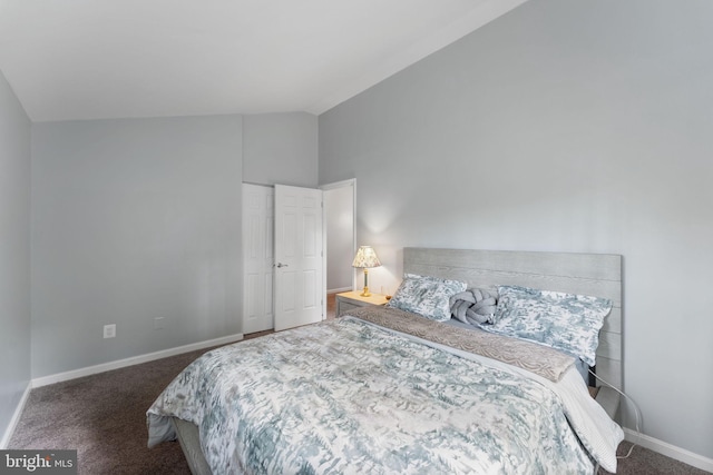 bedroom with vaulted ceiling, carpet floors, and baseboards