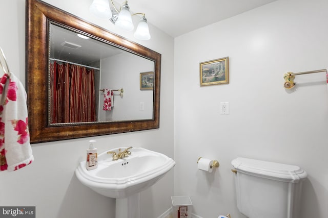 full bathroom featuring a shower with curtain, a sink, toilet, baseboards, and visible vents