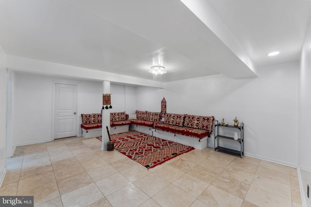 living room featuring baseboards and light tile patterned floors