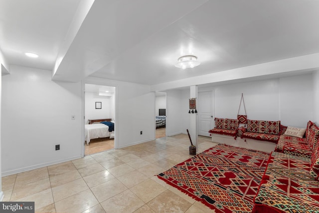 living room with baseboards and light tile patterned floors