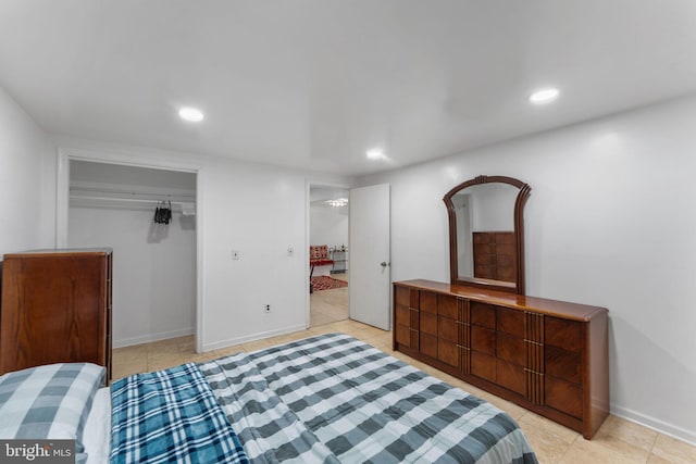bedroom with baseboards, recessed lighting, a closet, and light tile patterned floors