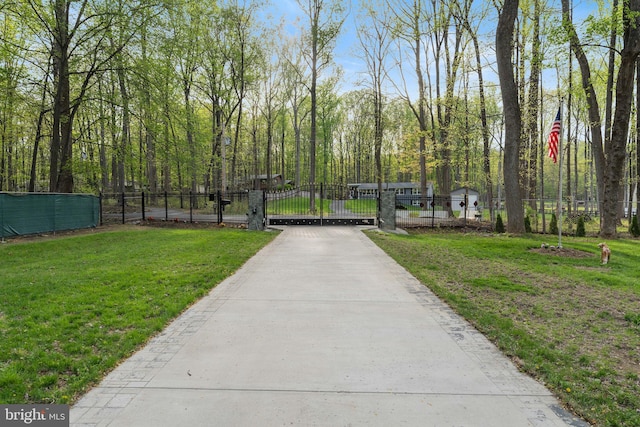 view of home's community featuring a gate, a lawn, and fence
